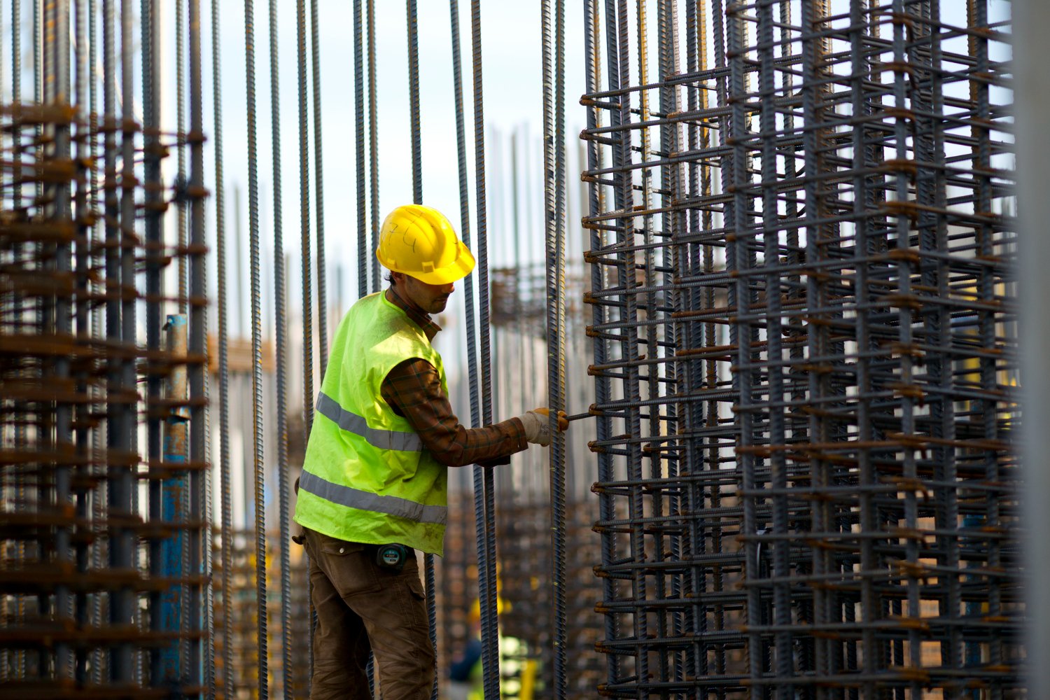 Hombre construyendo con varillas